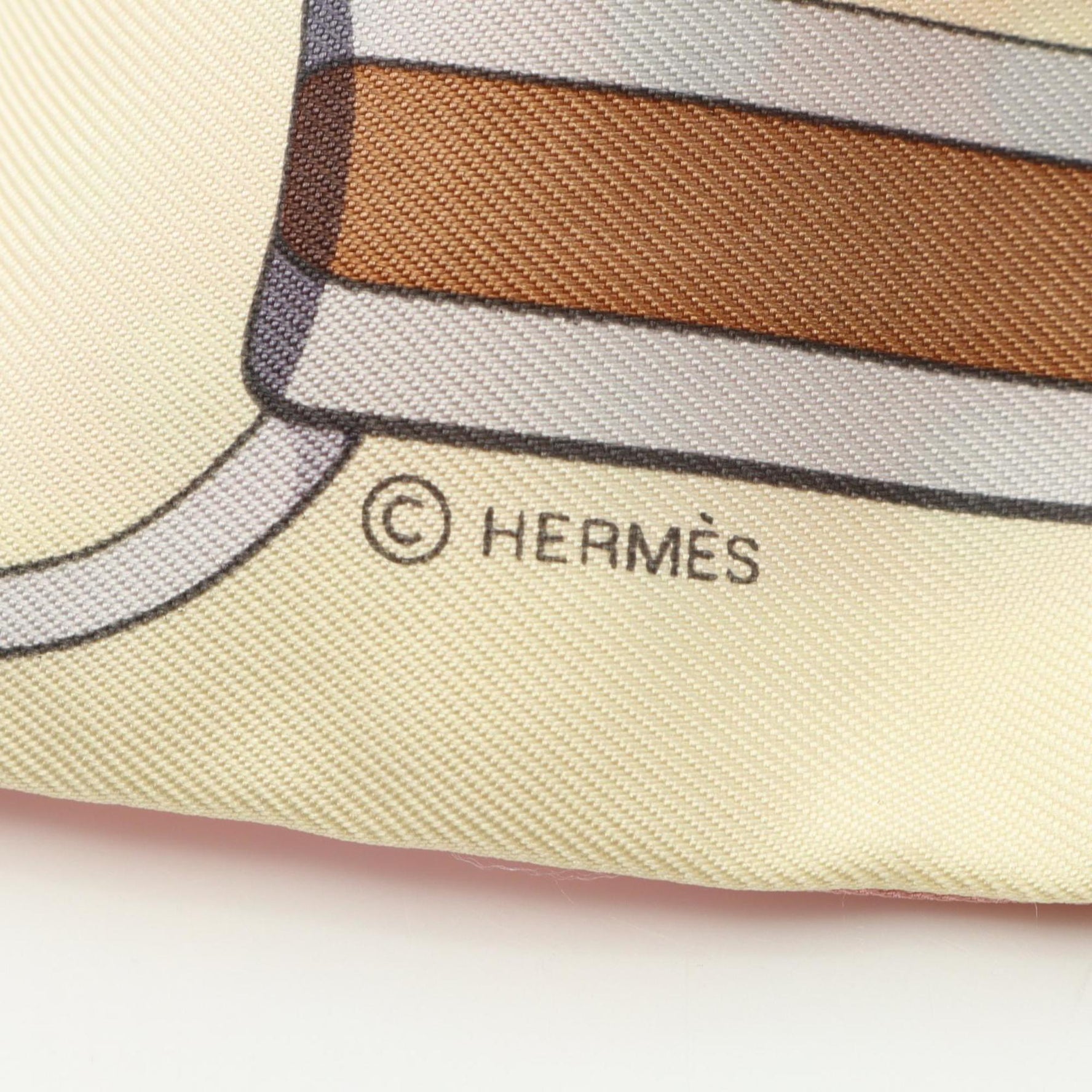 Hermes Hermès Twilly Grand TralaLa silk scarf in beige, pink, and multicolor.
