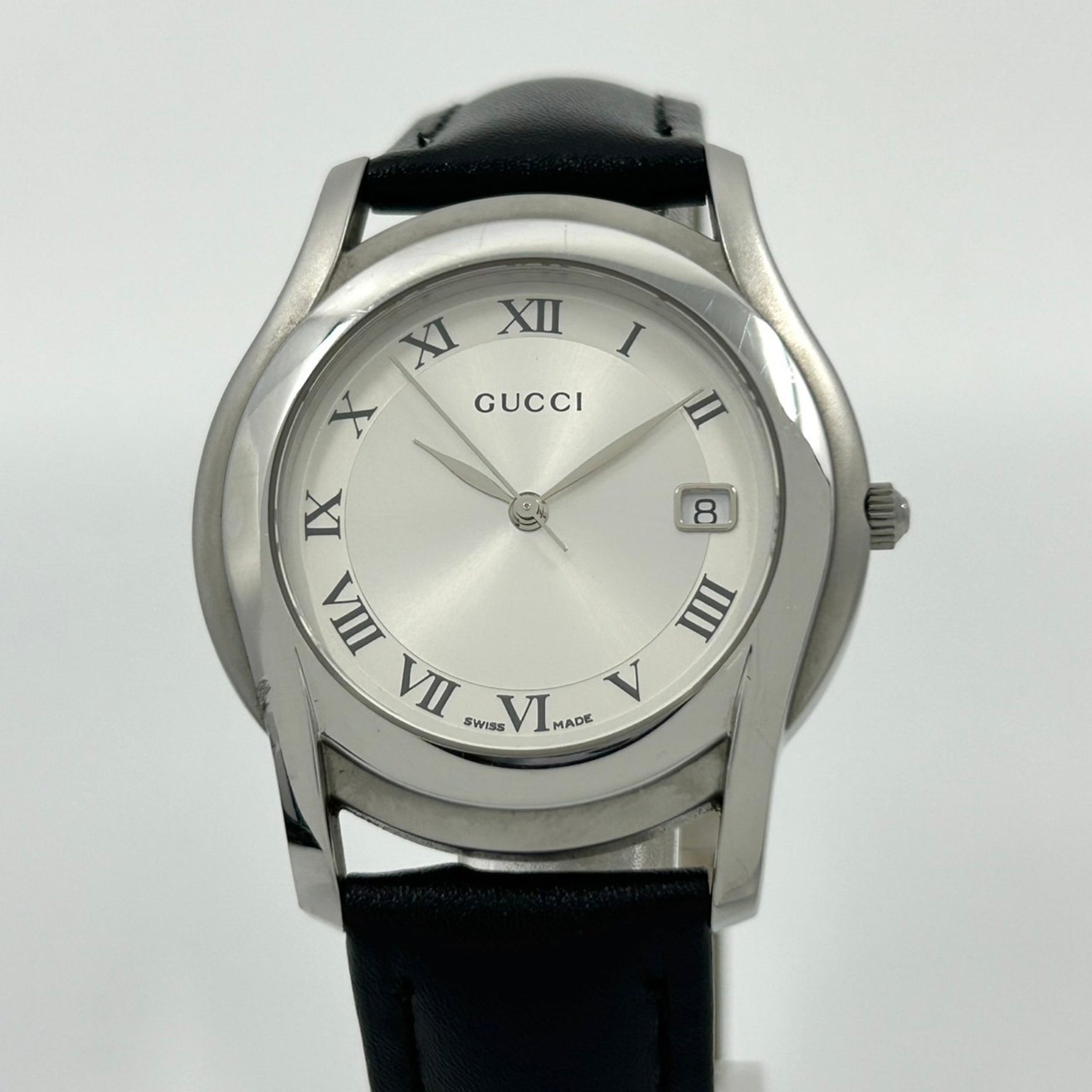 Gucci 5500M Men's Analog Quartz Watch with Silver Dial, Roman Numerals, Date Display, and Leather Strap, Black (G1)