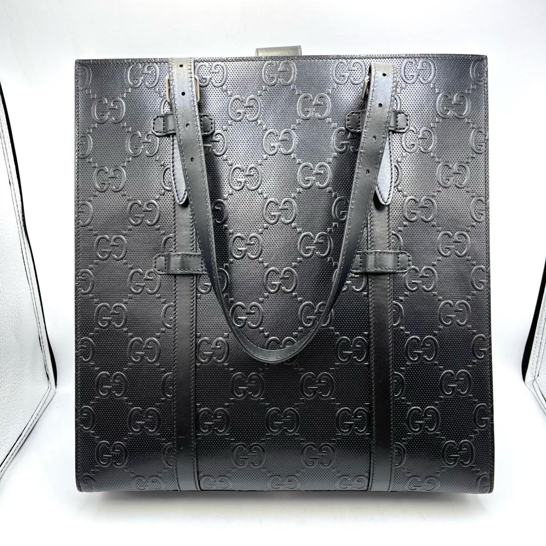 Gucci GG embossed perforated leather handbag in