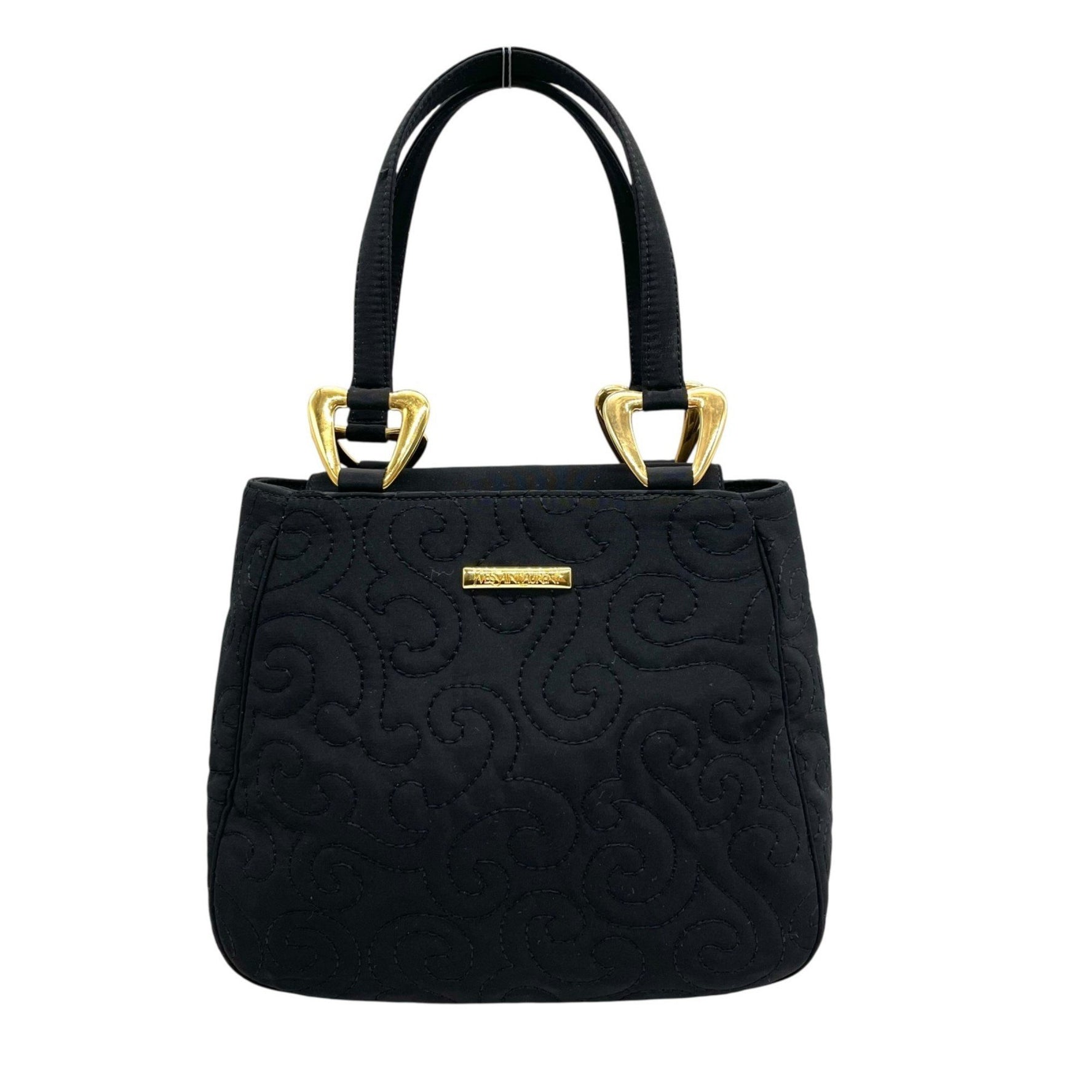 Yves Saint Laurent handbag in with gold hardware and a quilted swirl pattern.